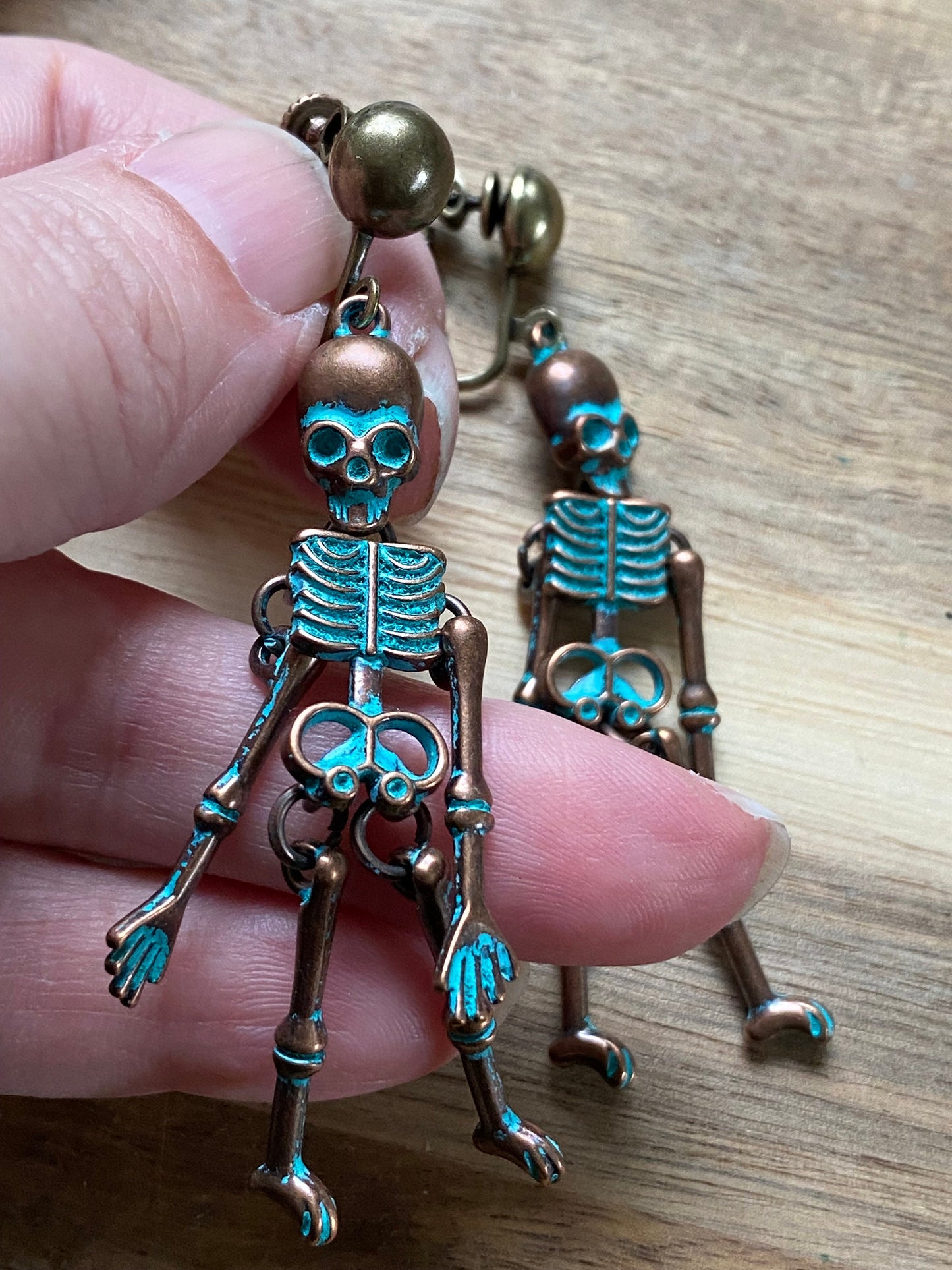 Bronze clip on skeleton earrings, dangling skellies with hinged screwback closures