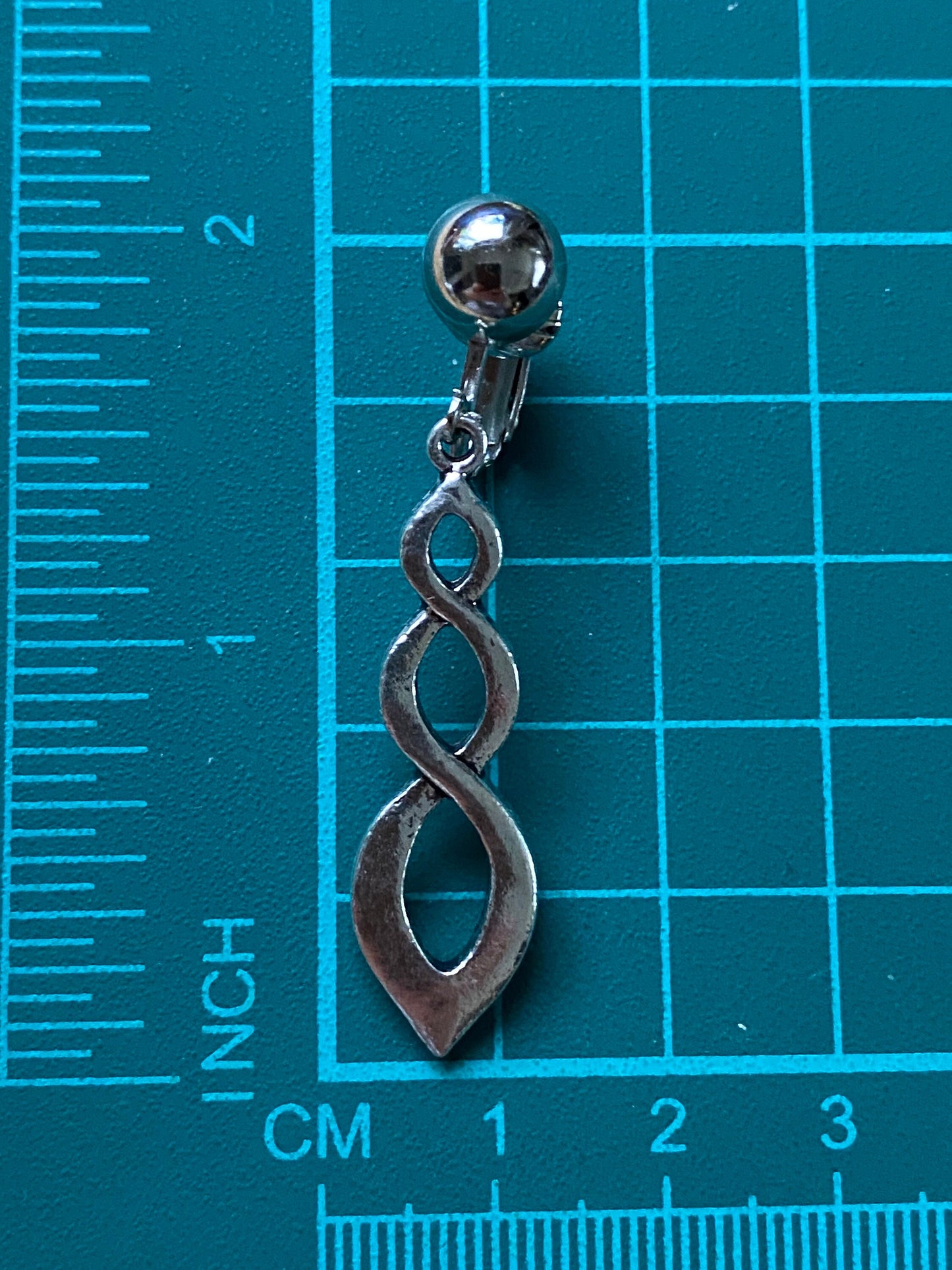 Dangling clip on silver infinity earrings