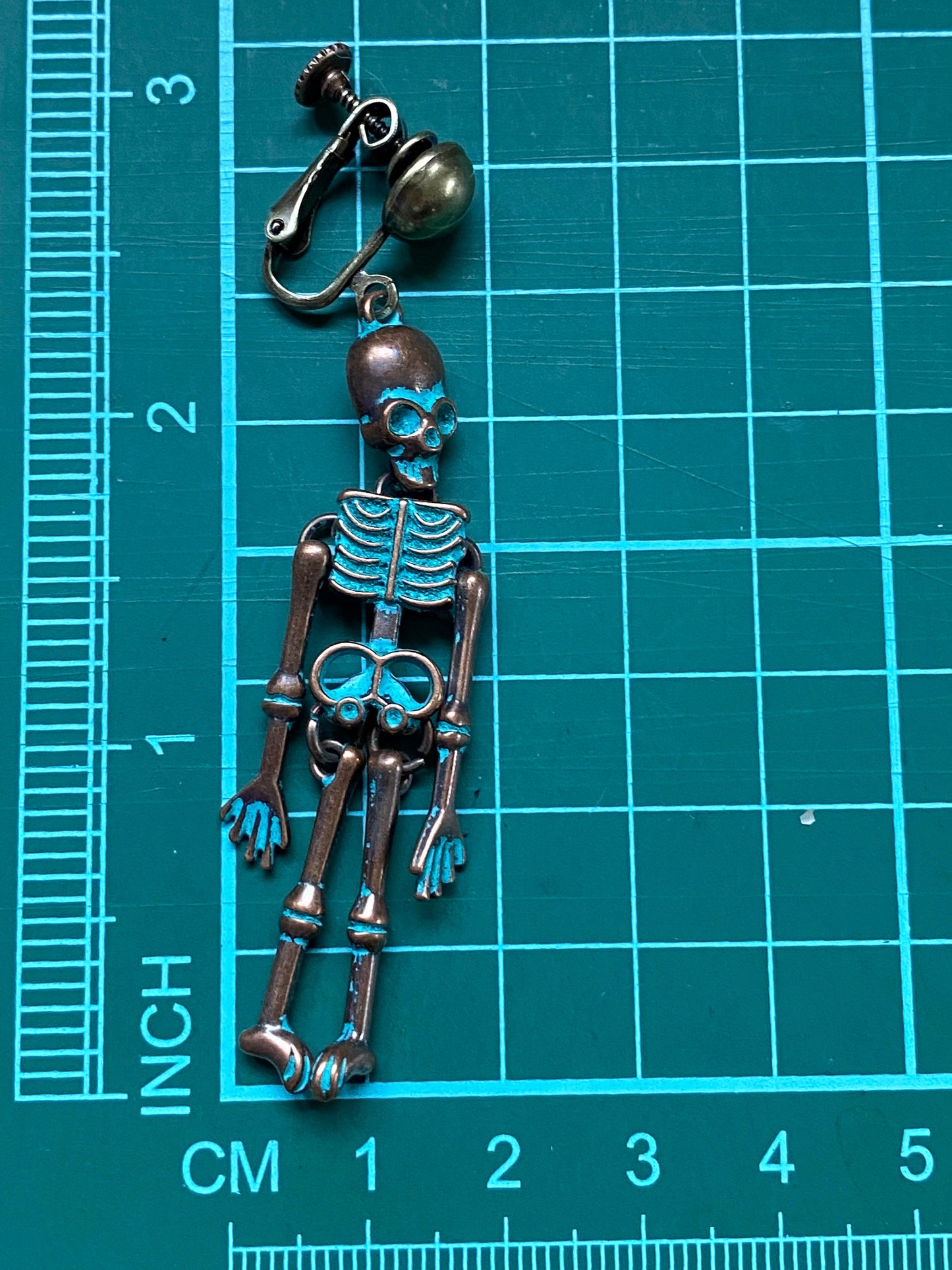 Bronze clip on skeleton earrings, dangling skellies with hinged screwback closures