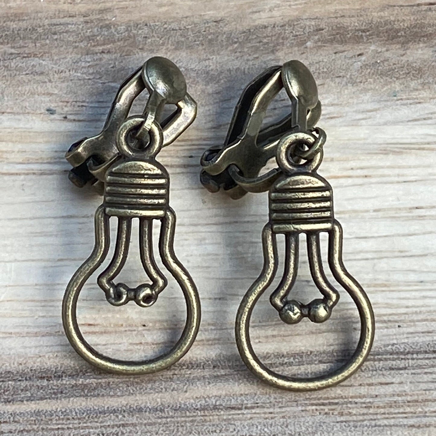 Adorable dangling lightbulb clip on earrings, cute bronze or silver earrings