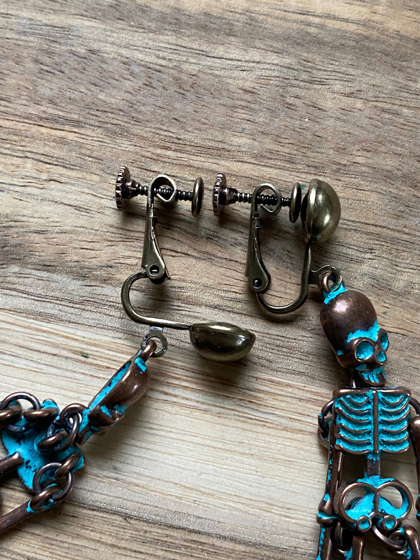 Bronze clip on skeleton earrings, dangling skellies with hinged screwback closures