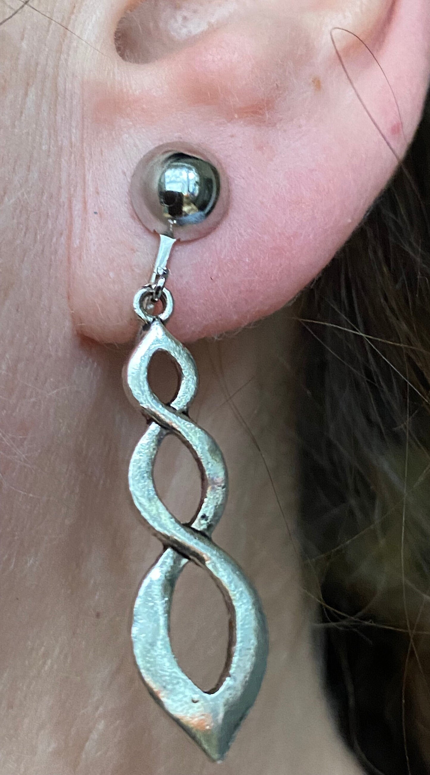 Dangling clip on silver infinity earrings