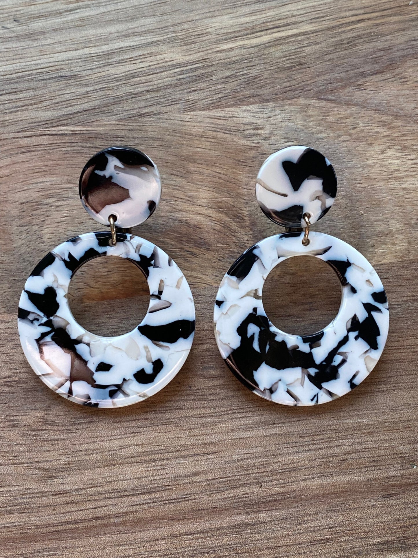 black and white dangling hoops with hinged screwback closures for unpierced ears