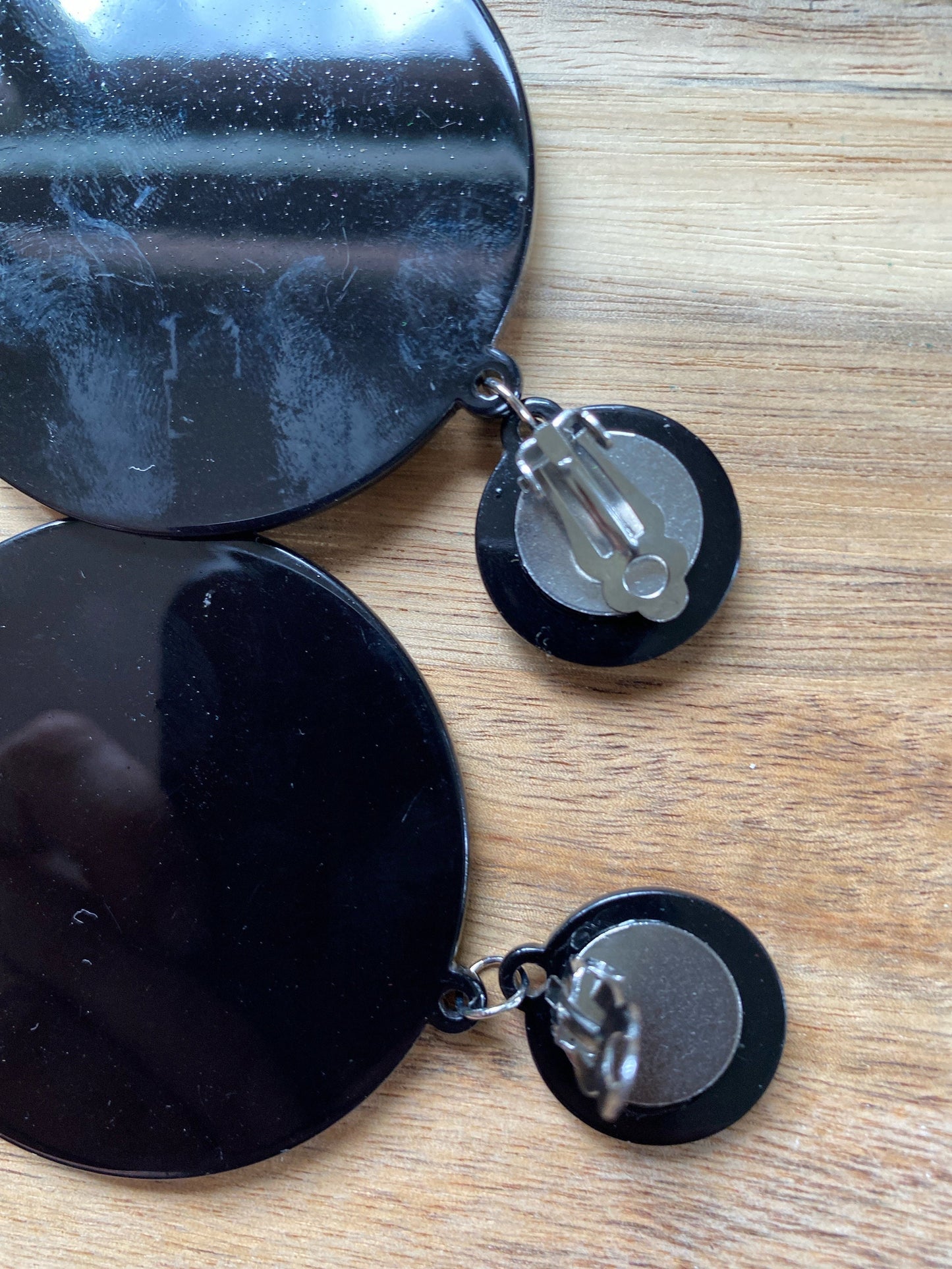 Oversized dangling black and white plastic swirl clip on earrings