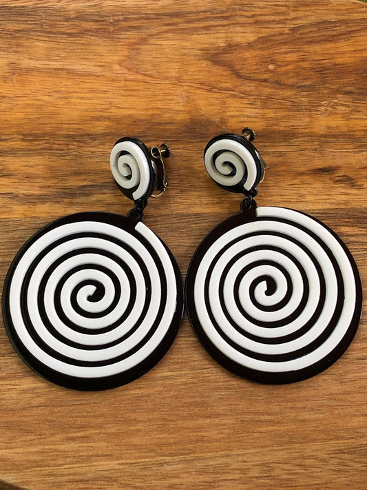 Oversized dangling black and white plastic swirl clip on earrings