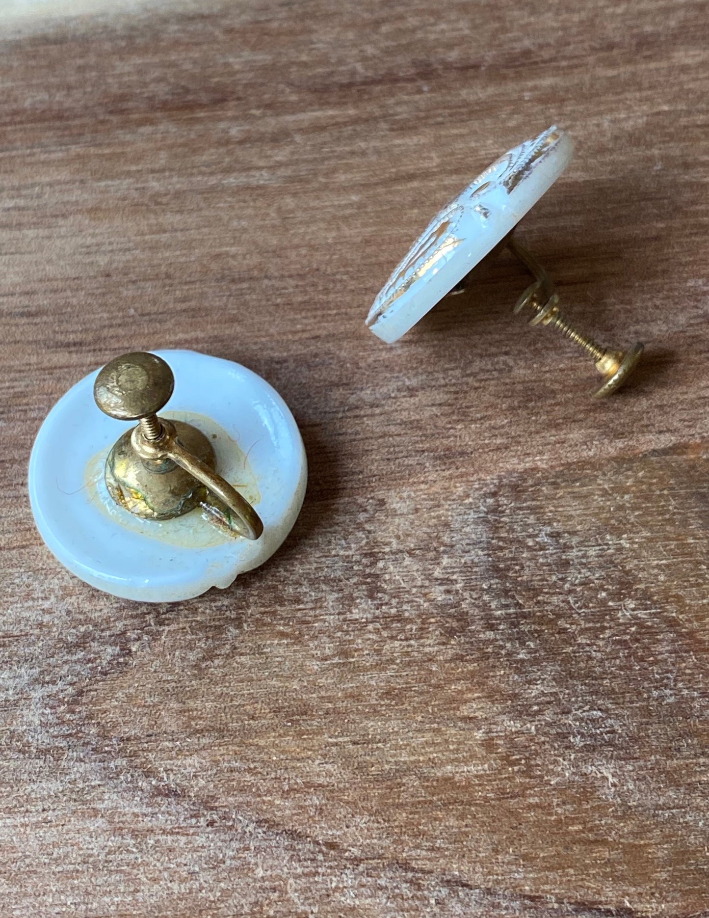 Vintage white plastic button clip on earrings with gold coloured paisley design