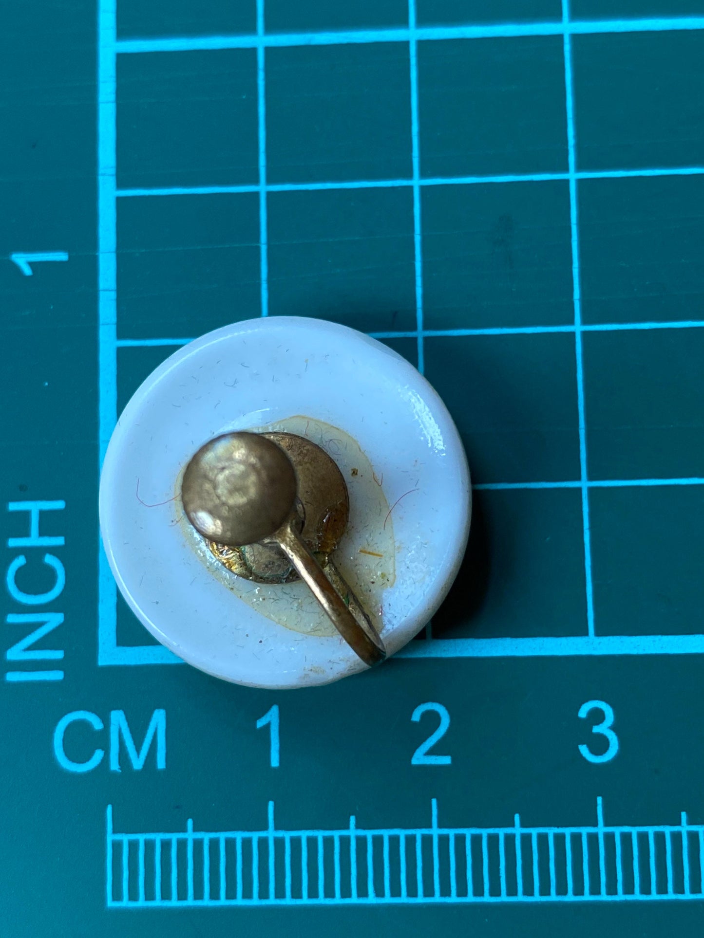 Vintage white plastic button clip on earrings with gold coloured paisley design
