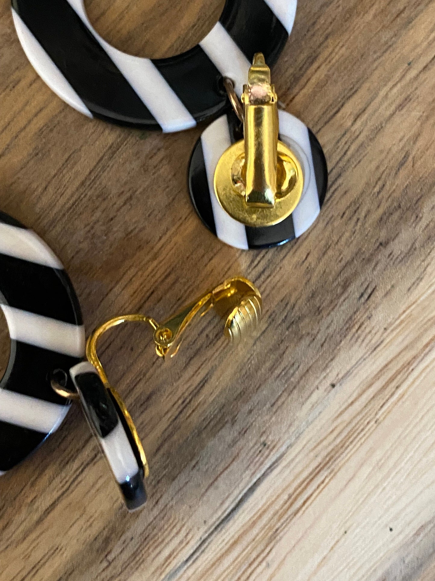 Dangling black and white striped plastic hoop clip on earrings