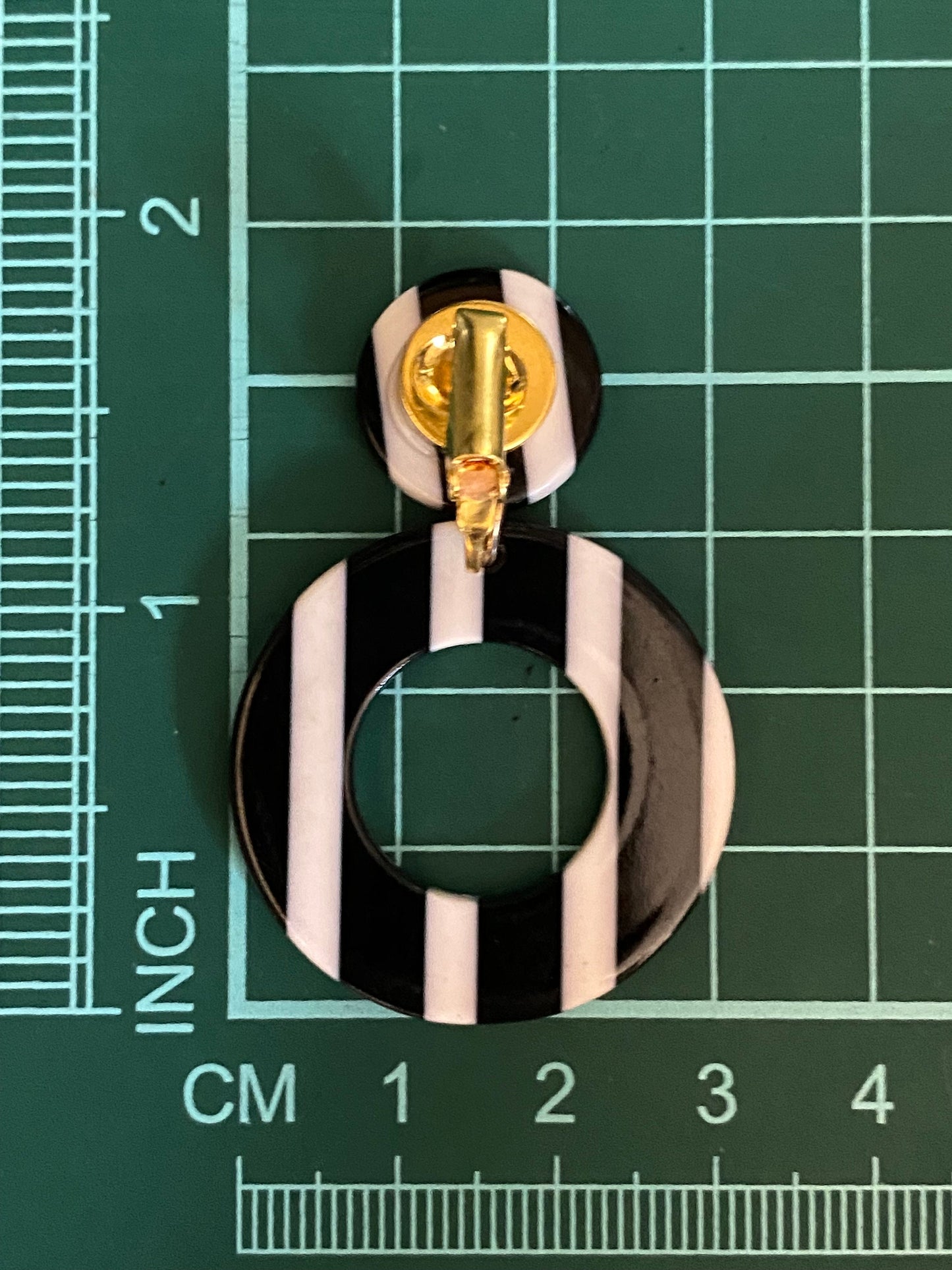 Dangling black and white striped plastic hoop clip on earrings