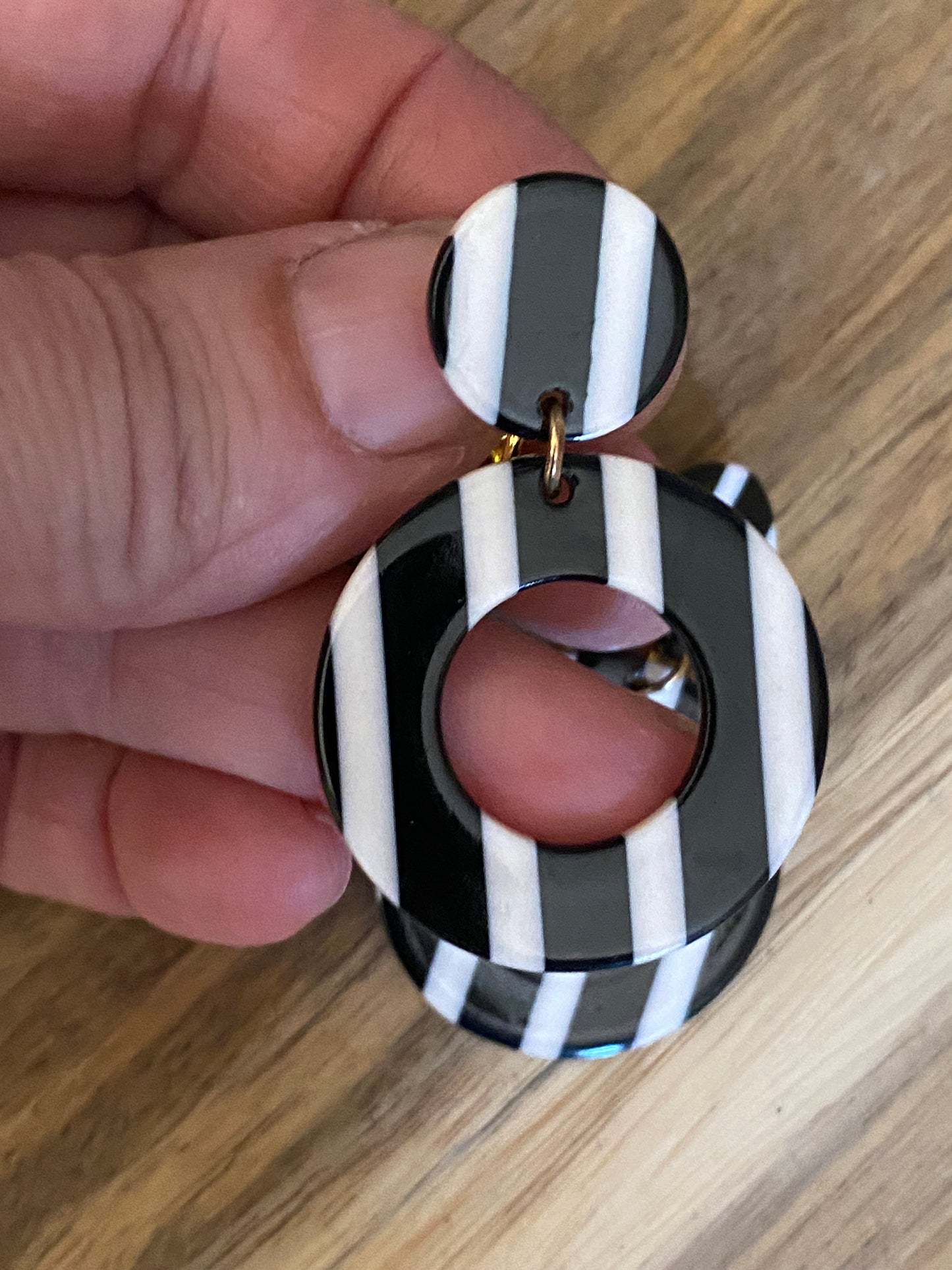 Dangling black and white striped plastic hoop clip on earrings
