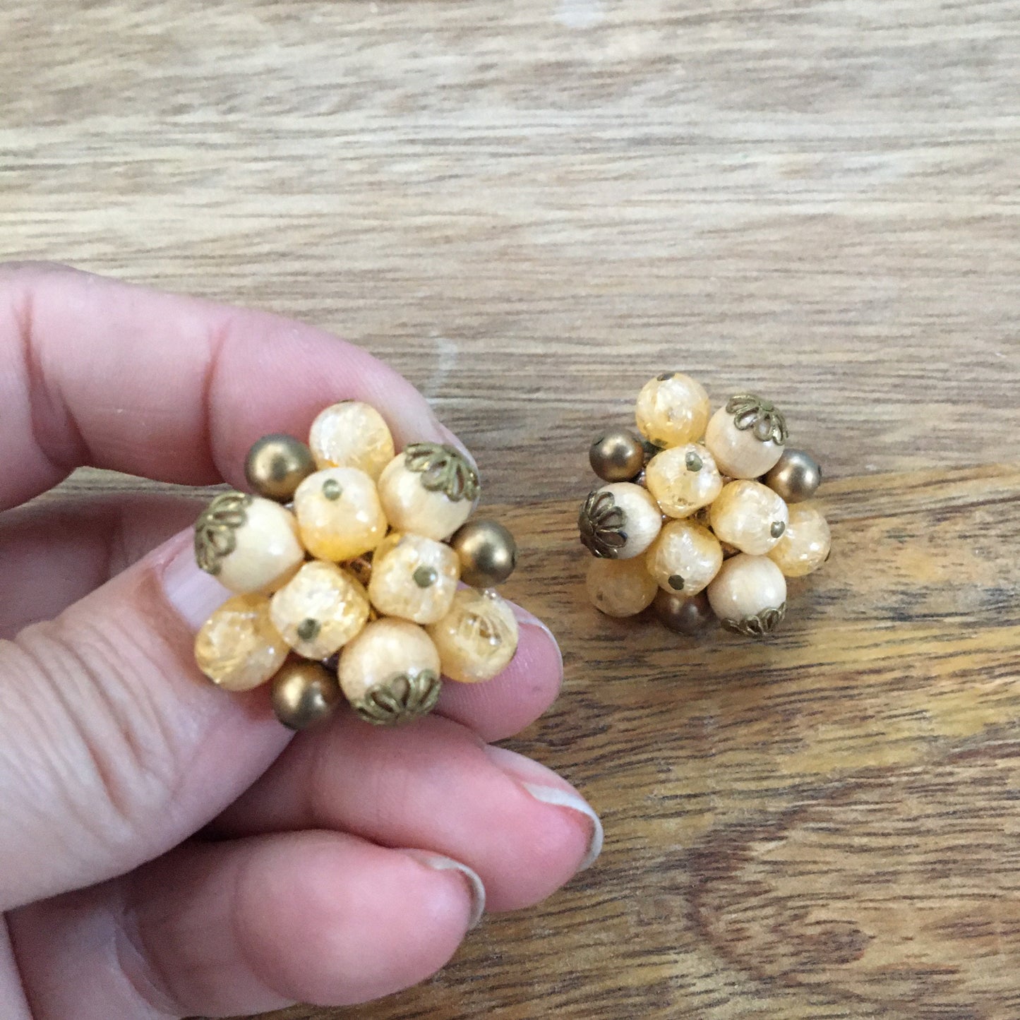 Vintage cream coloured cluster beaded clip on earrings with bronze details.