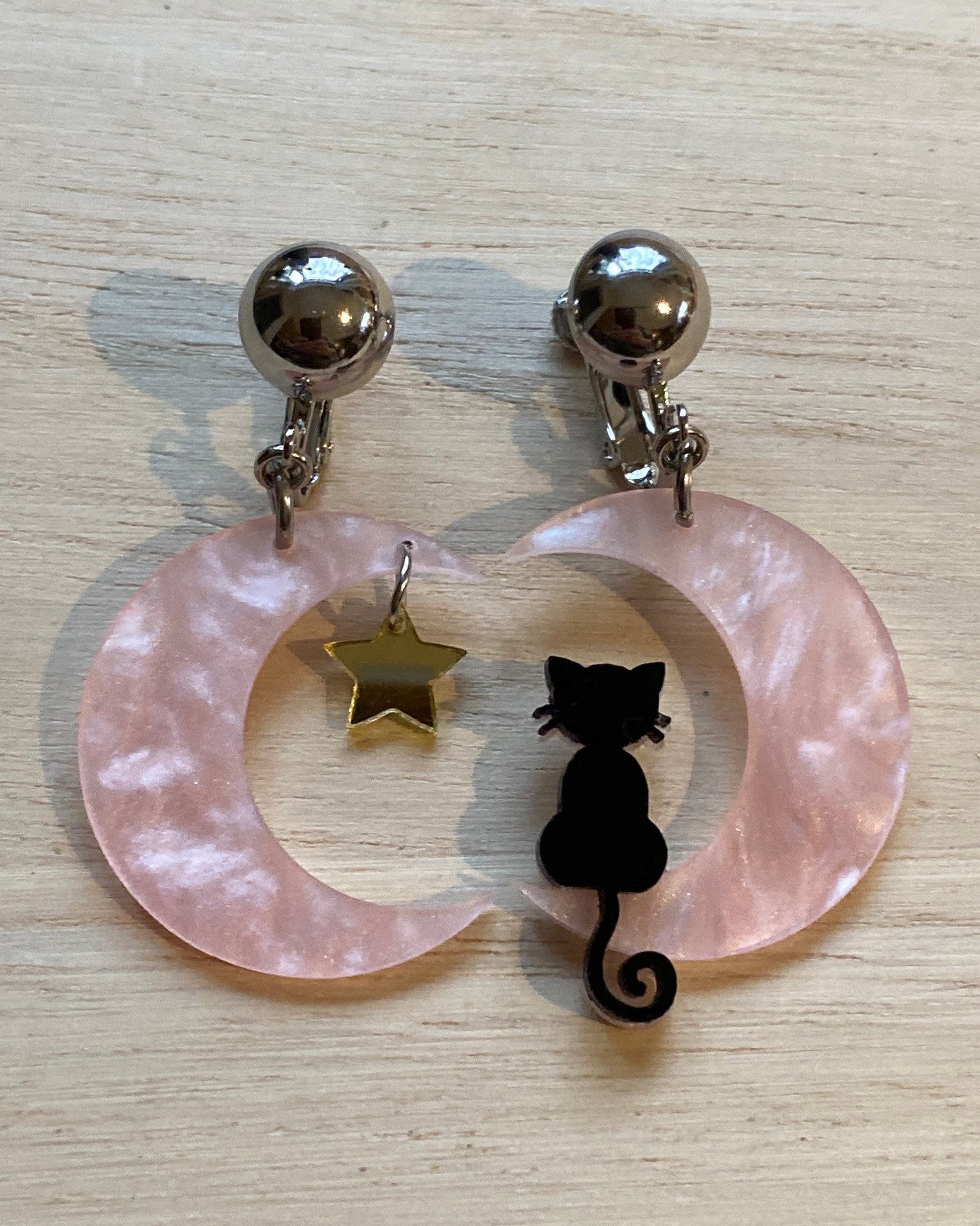 Black cat on a pink crescent moon clip on earrings