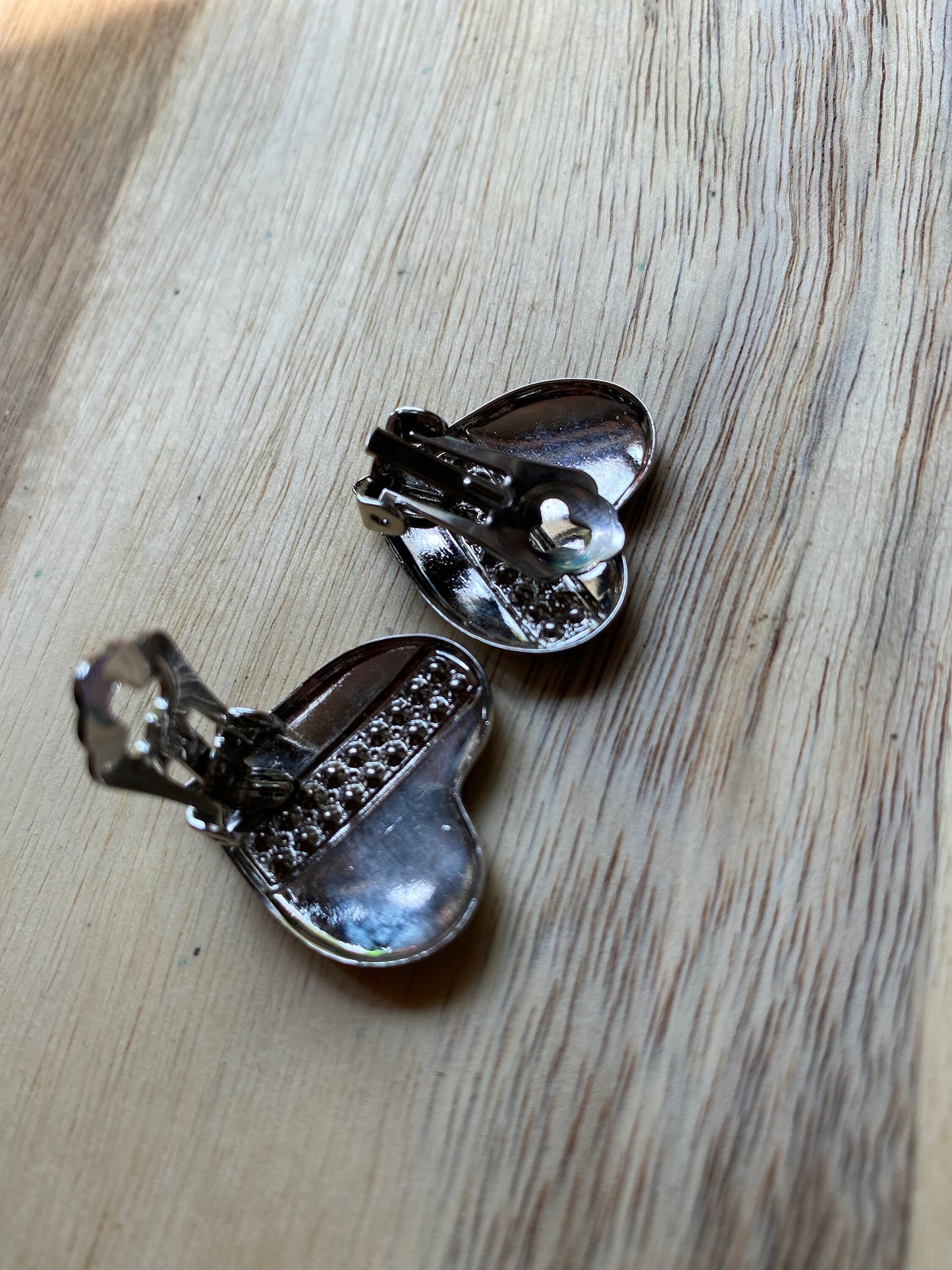 Vintage heart-shaped silver tone clip on earrings with rhinestone accents