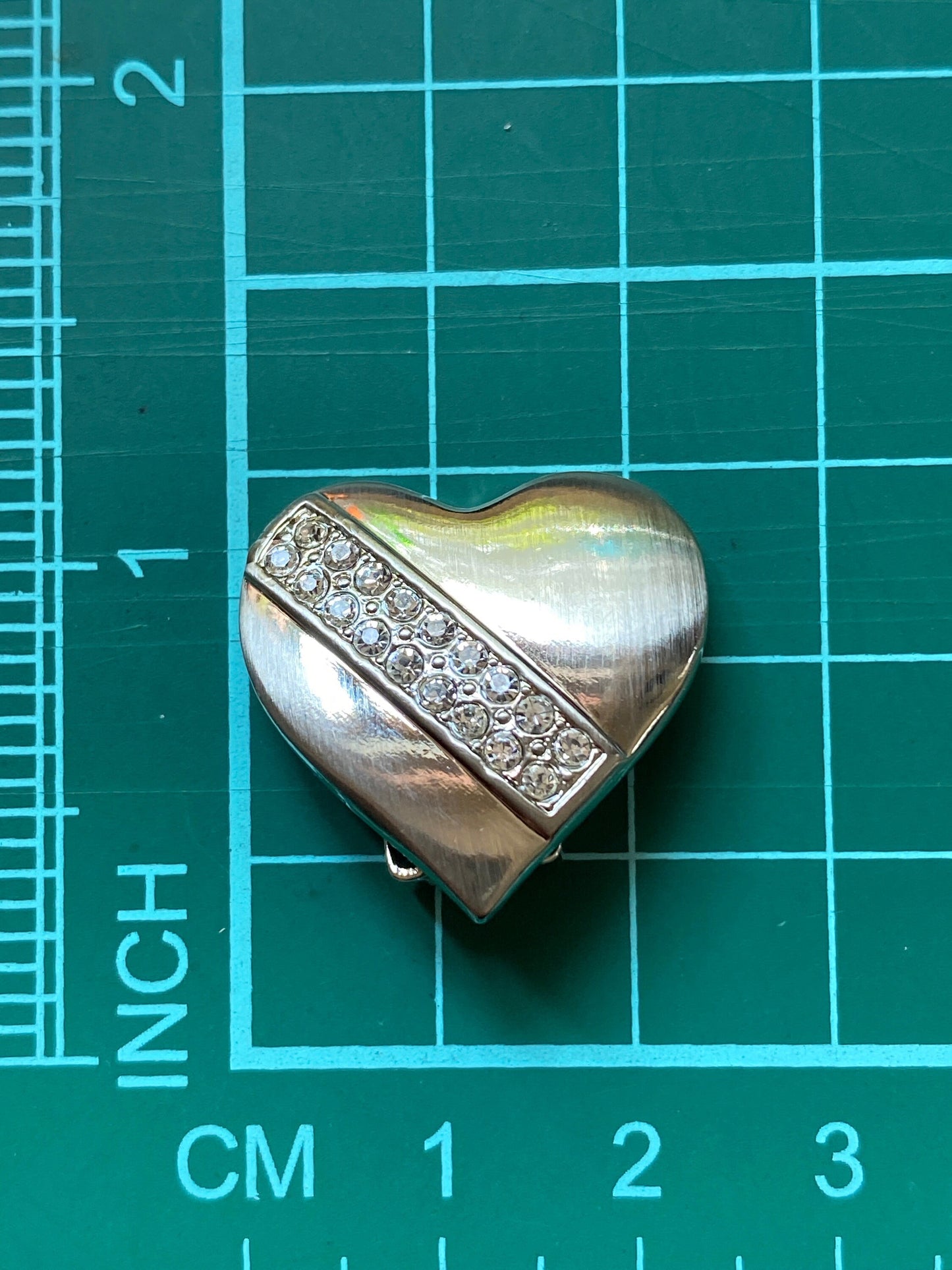 Vintage heart-shaped silver tone clip on earrings with rhinestone accents
